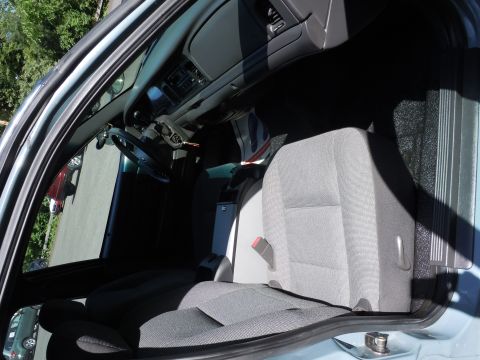 2001 Ford Crown Victoria - Interior view of a 2001 Ford Crown Victoria police car, highlighting the front seats and dashboard area.