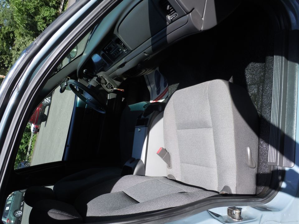 Interior of a 2001 Ford Crown Victoria police car, showing front seats and dashboard