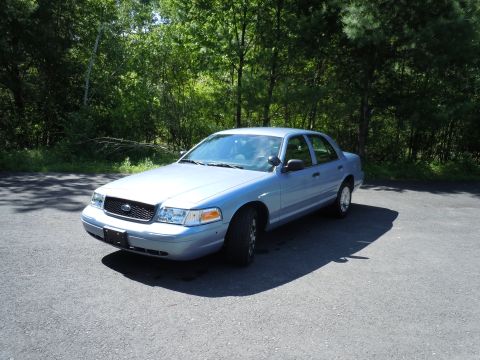 2001 Ford Crown Victoria - Light blue 2001 Ford Crown Victoria sedan parked outdoors on a sunny day.