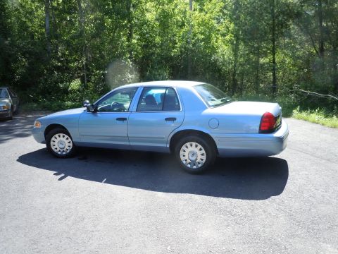 2001 Ford Crown Victoria - Side view of a light blue 2001 Ford Crown Victoria parked outdoors.