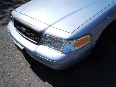 2001 Ford Crown Victoria - Front corner view of a 2001 Ford Crown Victoria, highlighting its distinctive grille and headlight assembly.