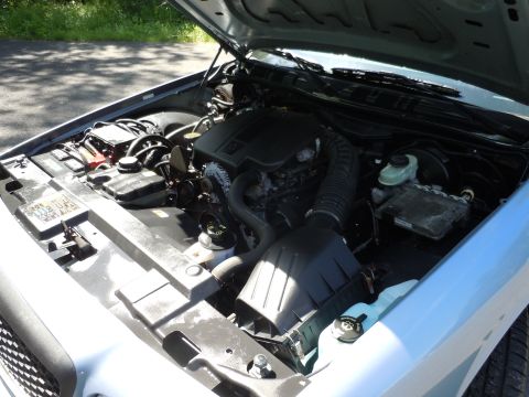 2001 Ford Crown Victoria - The engine bay of a 2001 Ford Crown Victoria is shown with the hood open.