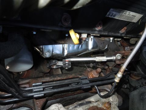 2001 Ford Crown Victoria - Close-up view of engine components, including the oil pan and dipstick.