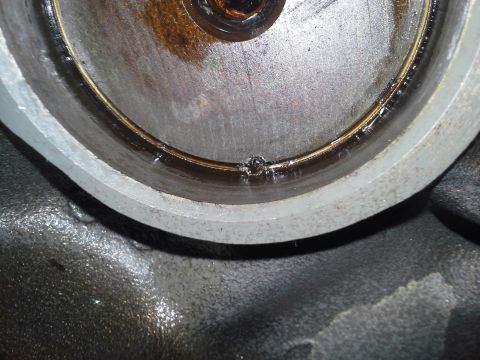 1991 Ford F-250 - This is a close-up view of a greasy engine component, possibly showing wear or a leak.