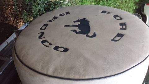 1991 Ford Bronco - A tan spare tire cover displays the Ford Bronco logo and text.