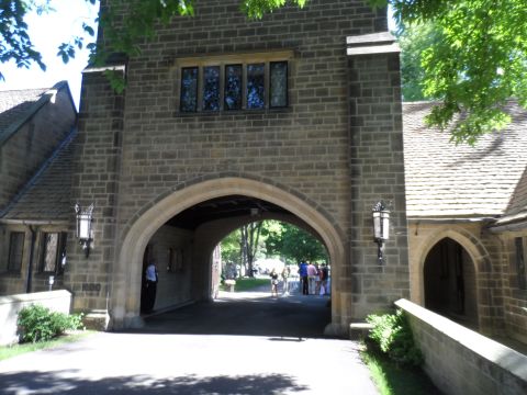 1971 Ford Ranchero - A stone archway leads to a courtyard with several people visible in the distance.