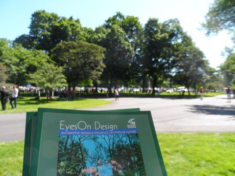 1971 Ford Ranchero - A sign for 'EyesOn Design' is in the foreground of a park scene with parked cars.
