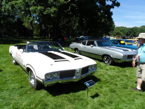 1971 Ford Ranchero - A white convertible and a silver coupe are parked on a grassy field under trees.