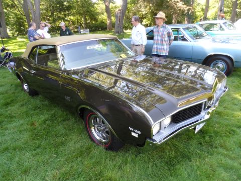 1971 Ford Ranchero - A classic convertible is displayed on a grassy lawn with other vehicles and people in the background.