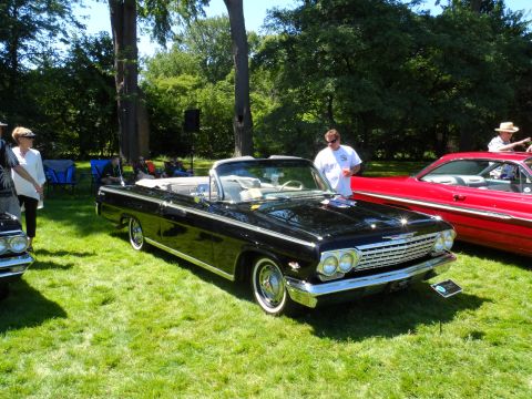 1971 Ford Ranchero - A black convertible with a distinctive chrome grille and whitewall tires is displayed on a sunny day.