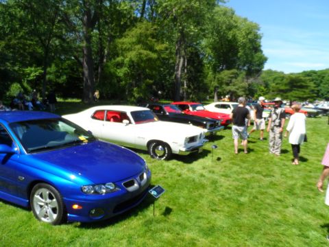 1971 Ford Ranchero - Several cars are on display at an outdoor event, with a modern blue car in the foreground.