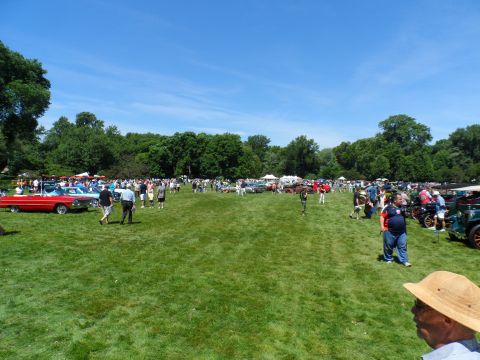 1971 Ford Ranchero - Numerous classic cars and attendees fill a park on a clear, sunny day.