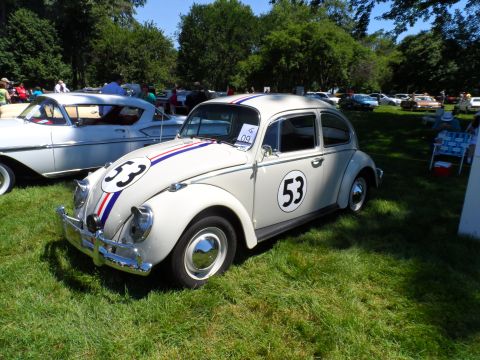 1971 Ford Ranchero - A classic Volkswagen Beetle, painted to resemble Herbie the Love Bug, is displayed on a grassy field.