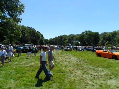 1971 Ford Ranchero - An outdoor car show displays numerous vehicles and attendees under a clear blue sky.