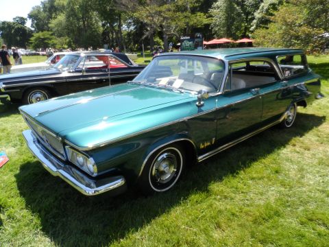 1971 Ford Ranchero - A vintage green station wagon is displayed on a sunny day at an outdoor event.