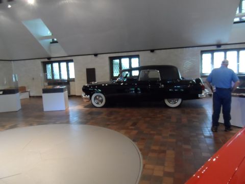 1971 Ford Ranchero - A black car with distinctive white-wall tires is displayed indoors, possibly in a museum or showroom.