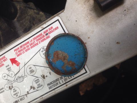 1988 Ford Bronco - A diagram shows engine belt routing, with a rusty blue cap nearby.