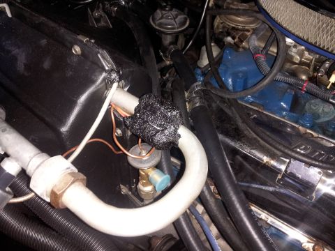 1976 Ford Ranchero - The photo shows a section of an engine bay focusing on air conditioning lines and some engine components.