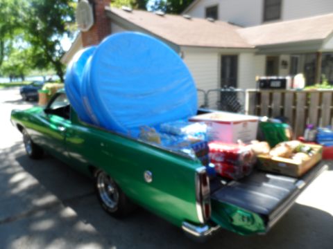 1971 Ford Ranchero - 1971 Ford Ranchero loaded with supplies and a large blue tarp in the bed.