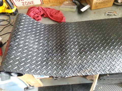 1992 Ford Bronco - Diamond plate matting is shown rolled up, possibly for installation or storage.