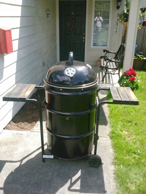 2008 Ford F-250 - Smoker grill with wooden side shelves sits on a patio next to a house entrance.