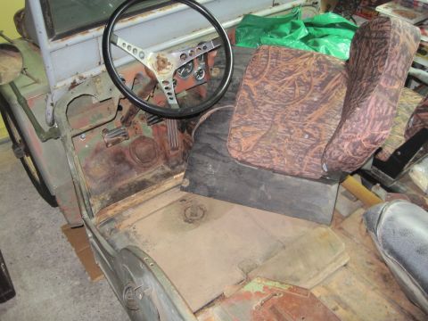 1946 Jeep CJ5 - Interior view of a 1946 Jeep CJ5, revealing its aged condition and basic controls.