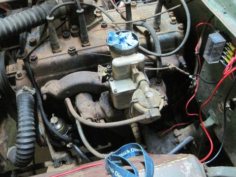1946 Jeep CJ5 - The engine bay of an older vehicle, a carburetor and visible wiring components.
