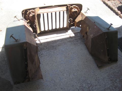 1946 Jeep CJ5 - Disassembled Jeep front clip including grille, headlights, and fenders.