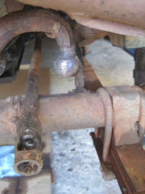 1946 Jeep Willys - The photo shows heavily rusted suspension parts, including a ball joint and leaf spring attachment points.