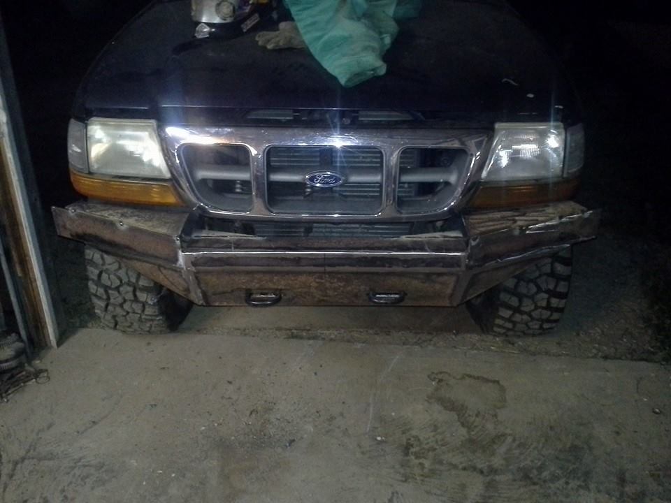 Black Ford Ranger front with custom metal bumper, off-road tires, and Ford grille