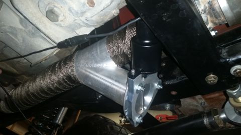 1968 Ford Bronco - Underside view of a vehicle's exhaust system, showing a heat-wrapped pipe and an attached valve.