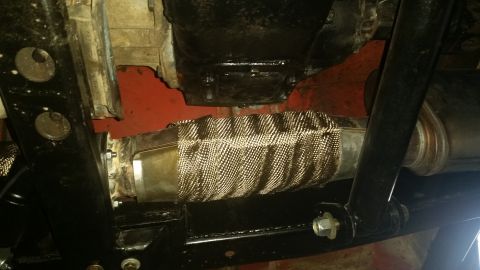 1968 Ford Bronco - Close-up view of an exhaust pipe section wrapped in heat-resistant material.