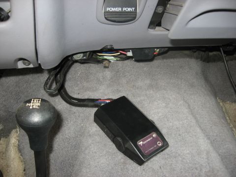 1994 Ford Bronco - Interior view of a trailer brake controller and 4x4 shifter.