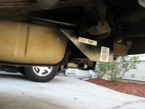 1994 Ford Bronco - Underside view of a vehicle's receiver hitch and fuel tank, with visible part numbers.