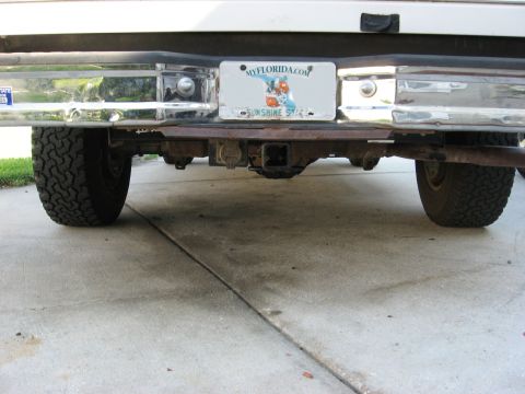 1994 Ford Bronco - Rear view of a 1994 Ford Bronco, showing the bumper, hitch, and tires. Florida license plate is mounted.