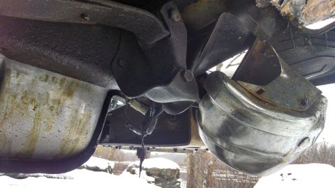 1995 Ford Bronco - Underside view of a vehicle's exhaust system, showing the muffler and associated components.