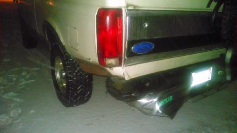 1995 Ford Bronco - This white Ford Bronco is seen from the rear, showing its chrome bumper and Ford emblem.