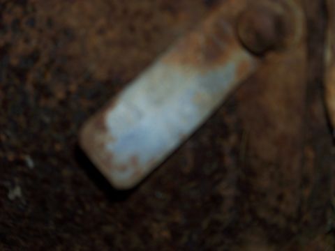 1999 Mercury Grand Marquis - This is a close-up of a rusted metal component, possibly from a vehicle's undercarriage.