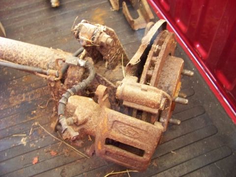 1999 Mercury Grand Marquis - This rusty Ford brake caliper and rotor assembly is a spare part.