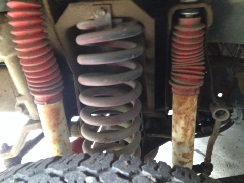 1978 Ford Bronco - This image shows the suspension system of a vehicle, including coil springs and shock absorbers.