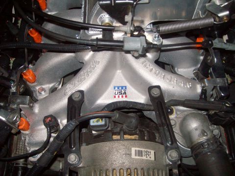 2004 Ford Crown Victoria - Close-up of an aftermarket aluminum intake manifold with visible "Made in USA" branding and engine components.