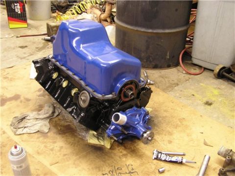 1993 Ford Bronco - Engine block and water pump assembly on a workbench, likely during a rebuild or restoration.