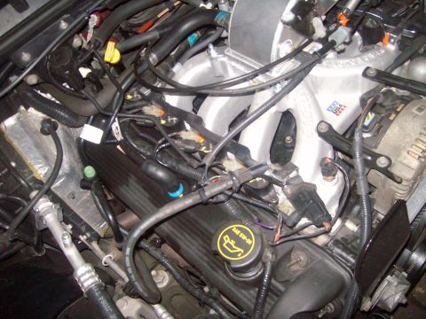 2004 Ford Crown Victoria - Close-up view of a vehicle's engine bay, showing intricate wiring and plumbing.