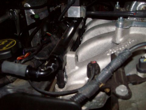 2004 Ford Crown Victoria - Close-up view of engine components, including the intake manifold and fuel rail.