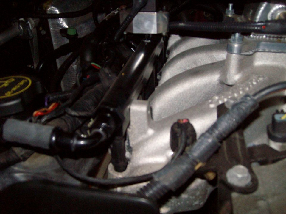 Engine intake manifold and wiring harness with a black fuel rail