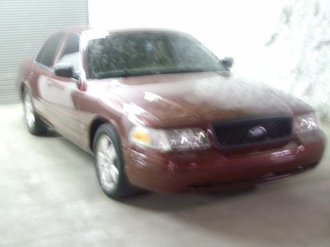 2004 Ford Crown Victoria - Maroon 2004 Ford Crown Victoria sedan parked indoors.
