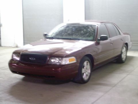 2004 Ford Crown Victoria - This maroon 2004 Ford Crown Victoria is shown from a 3/4 front angle.