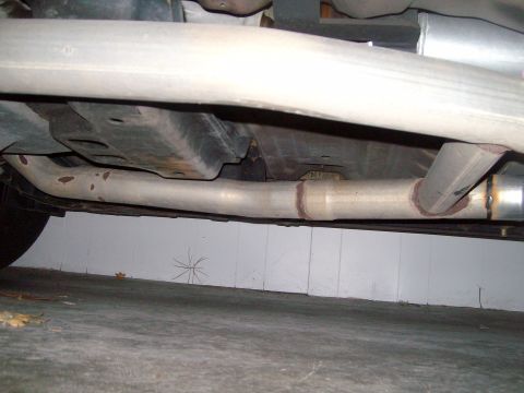 2004 Ford Crown Victoria - The underside of a vehicle shows its exhaust system components.