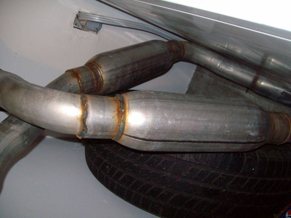 Exhaust system pipes and spare tire