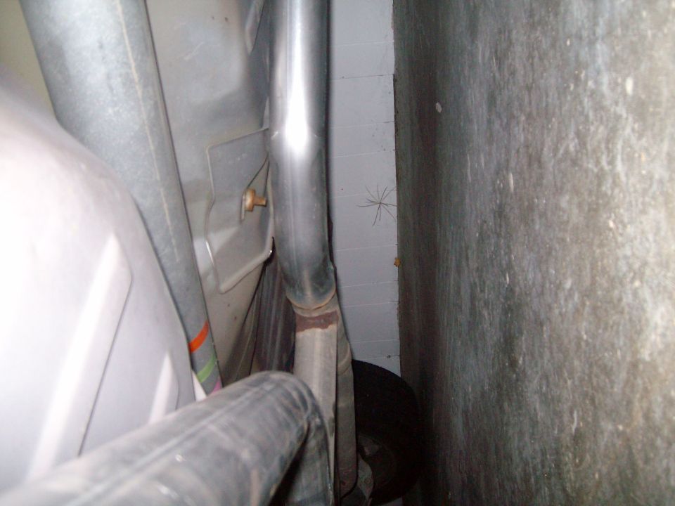 Underbody view showing exhaust pipe and part of the fuel tank area